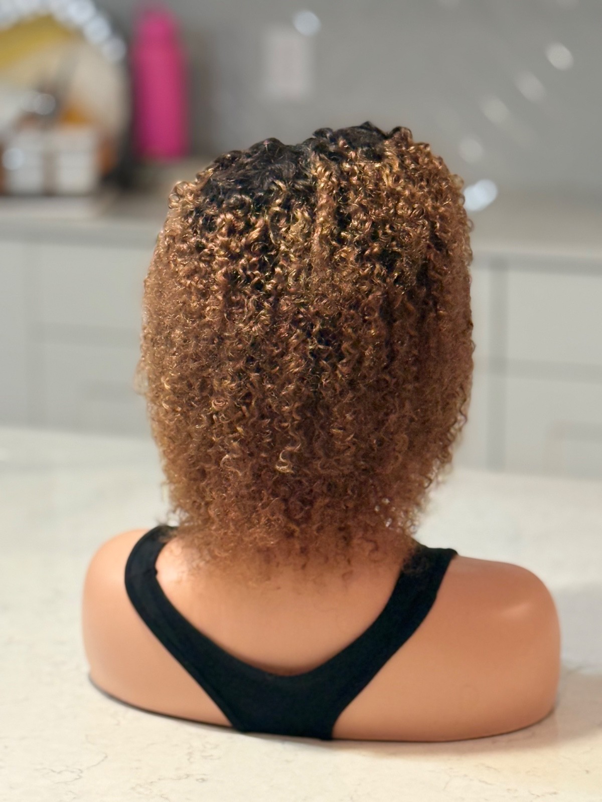 Human hair curly Afro brown wig with a side part.
