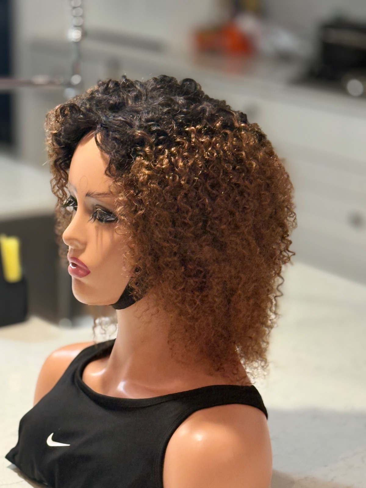 Human hair curly Afro brown wig with a side part.