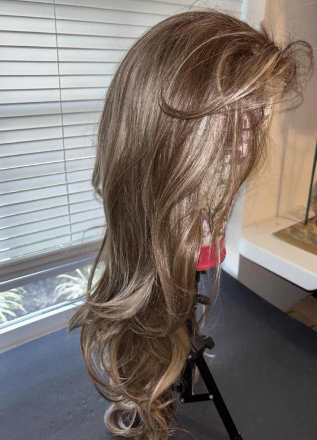 Lady Grayy long, wavy blonde synthetic wig with brown highlights. 26-28”